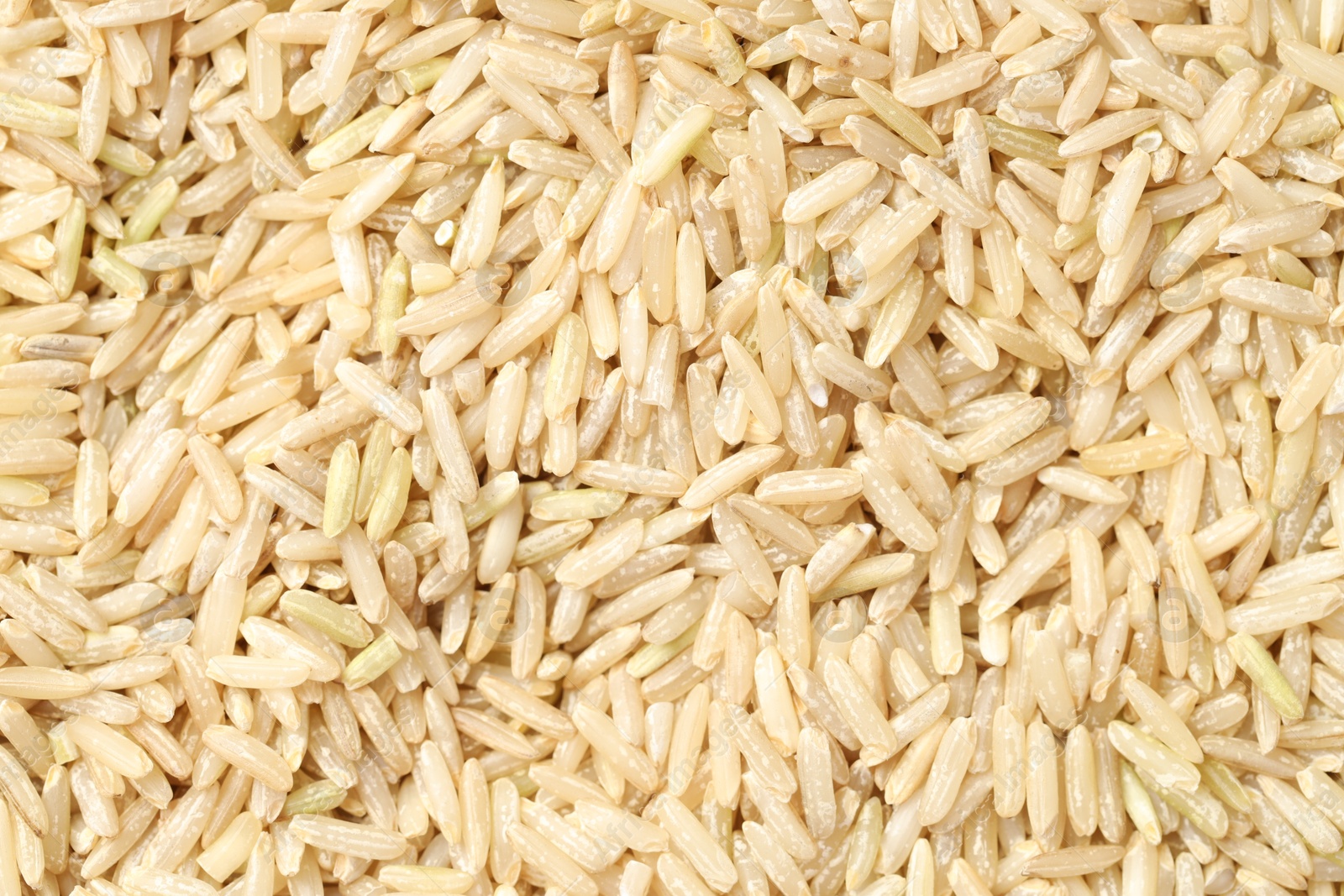 Photo of Pile of brown rice as background, top view