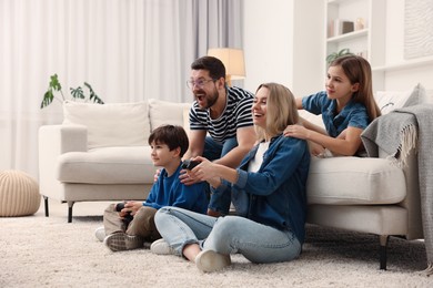 Photo of Happy family playing video games at home