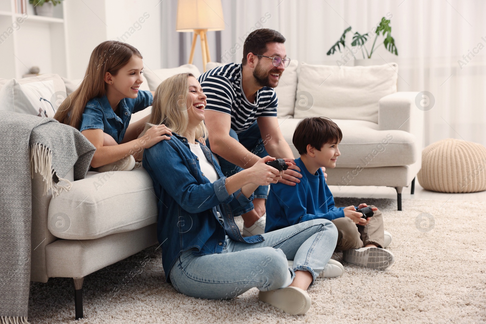 Photo of Happy family playing video games at home