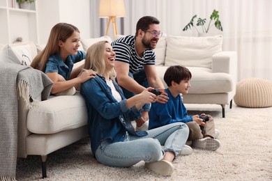 Photo of Happy family playing video games at home