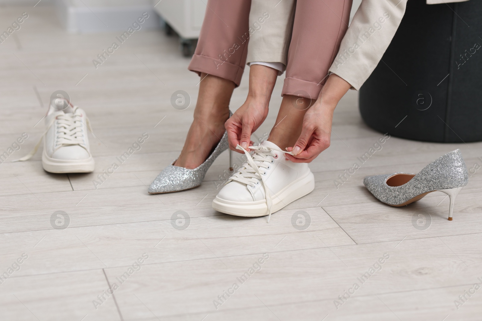 Photo of Woman changing shoes at home, closeup view