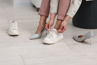 Photo of Woman changing shoes at home, closeup view