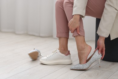 Photo of Woman changing shoes at home, closeup. Space for text