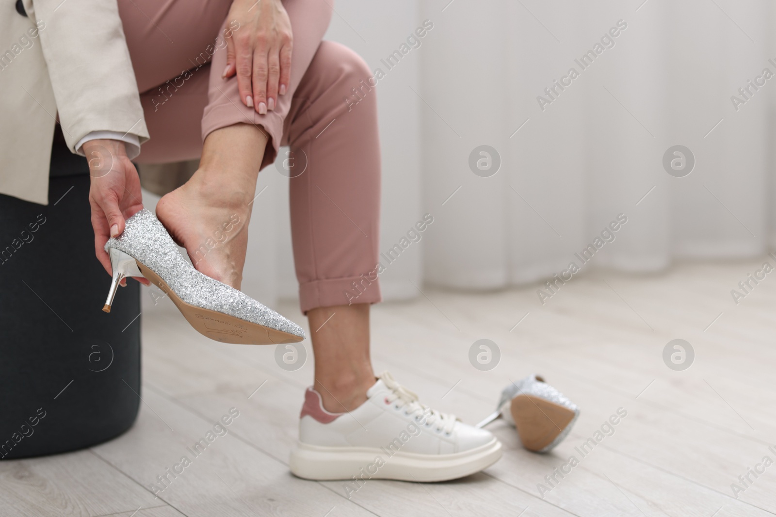 Photo of Woman changing shoes at home, closeup. Space for text