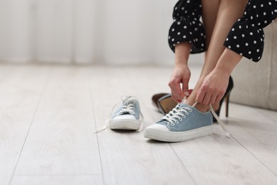 Photo of Woman changing shoes at home, closeup. Space for text