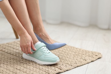 Photo of Woman changing shoes at home, closeup. Space for text