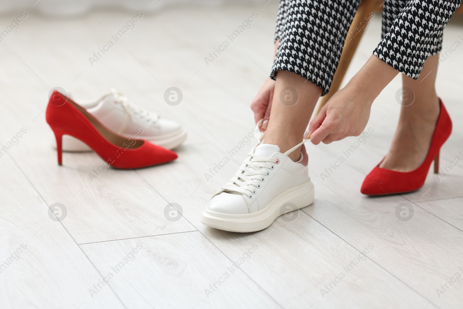 Photo of Woman changing shoes at home, closeup view