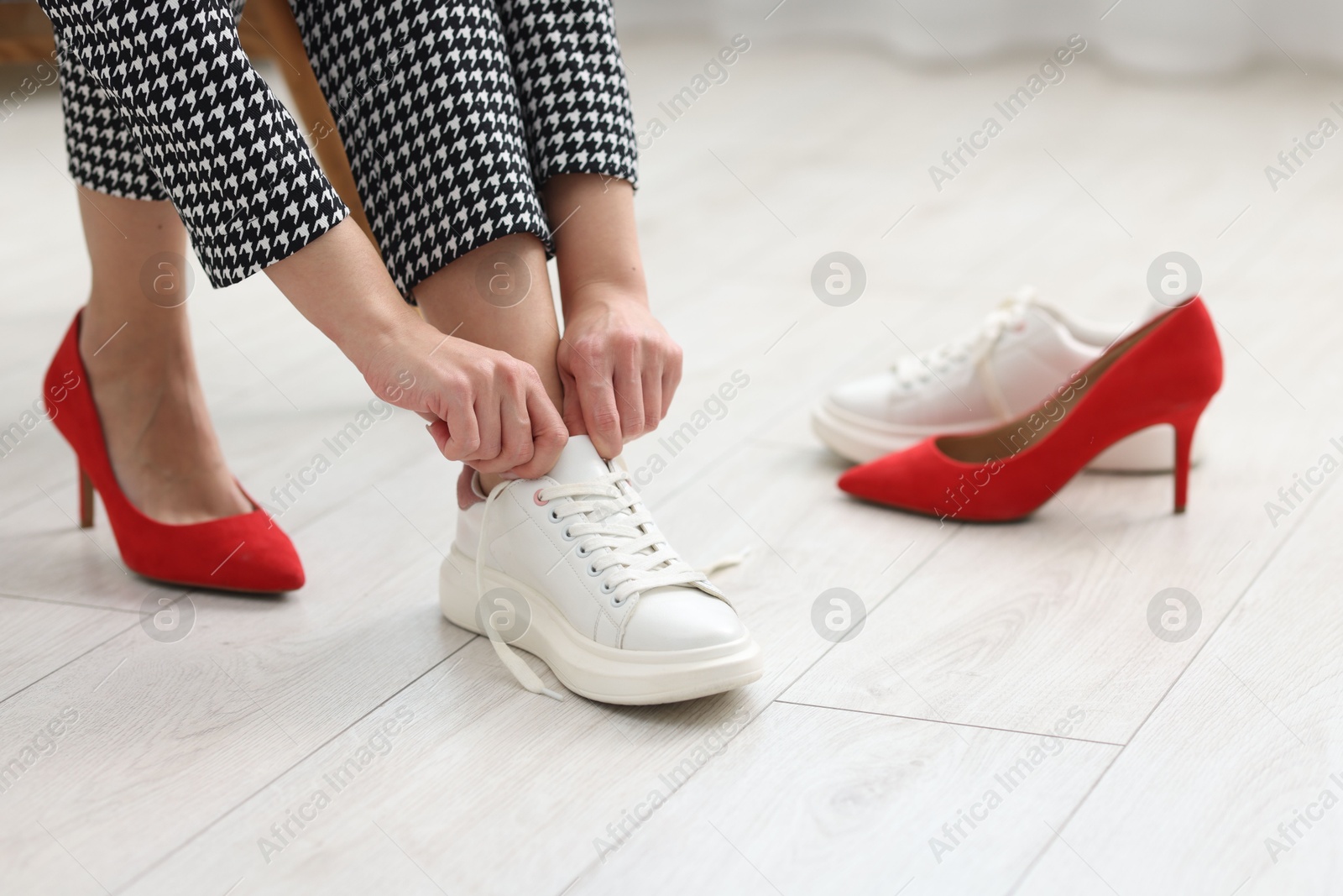 Photo of Woman changing shoes at home, closeup view