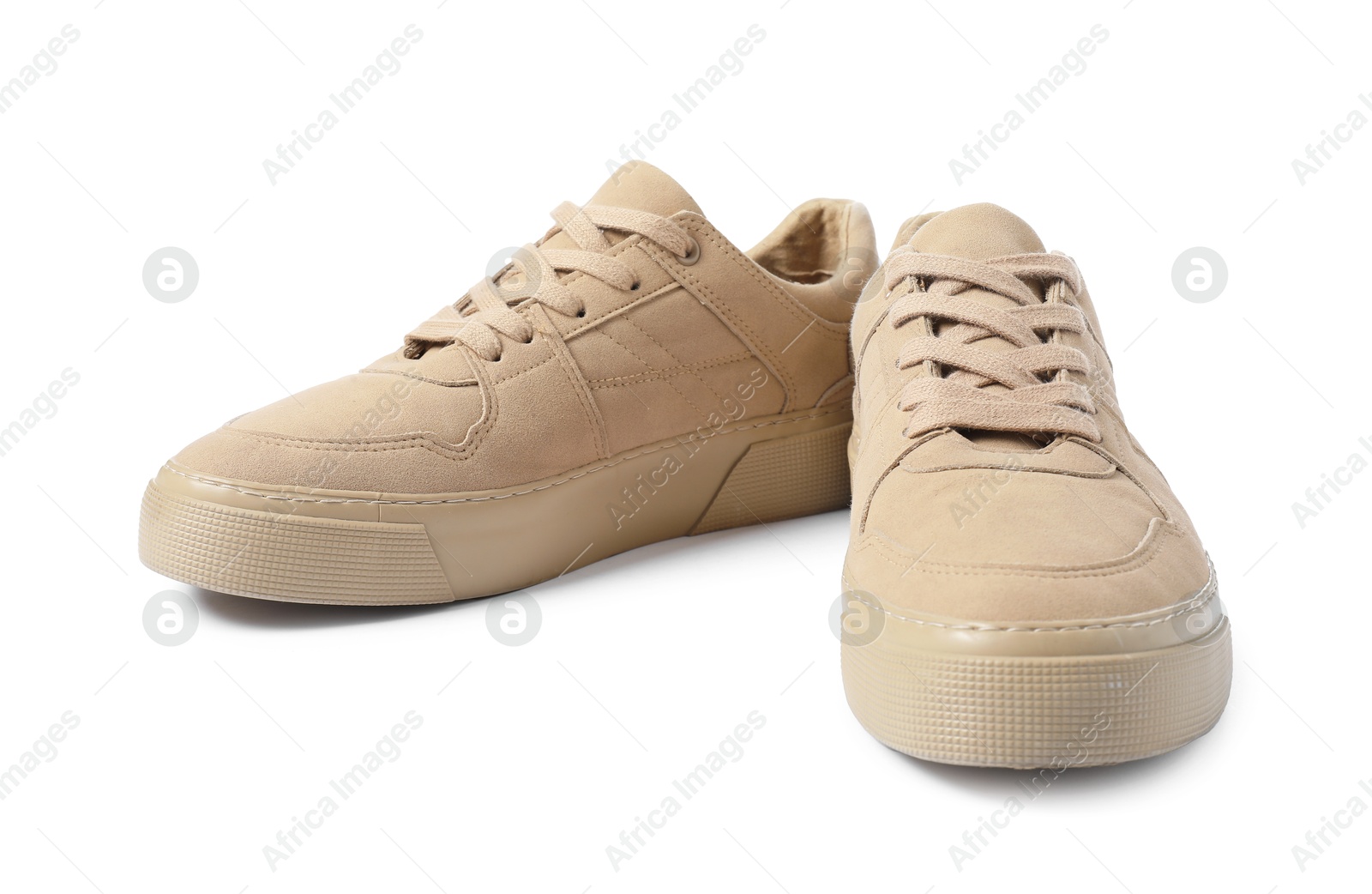 Photo of Pair of beige sneakers isolated on white. Sportive shoes