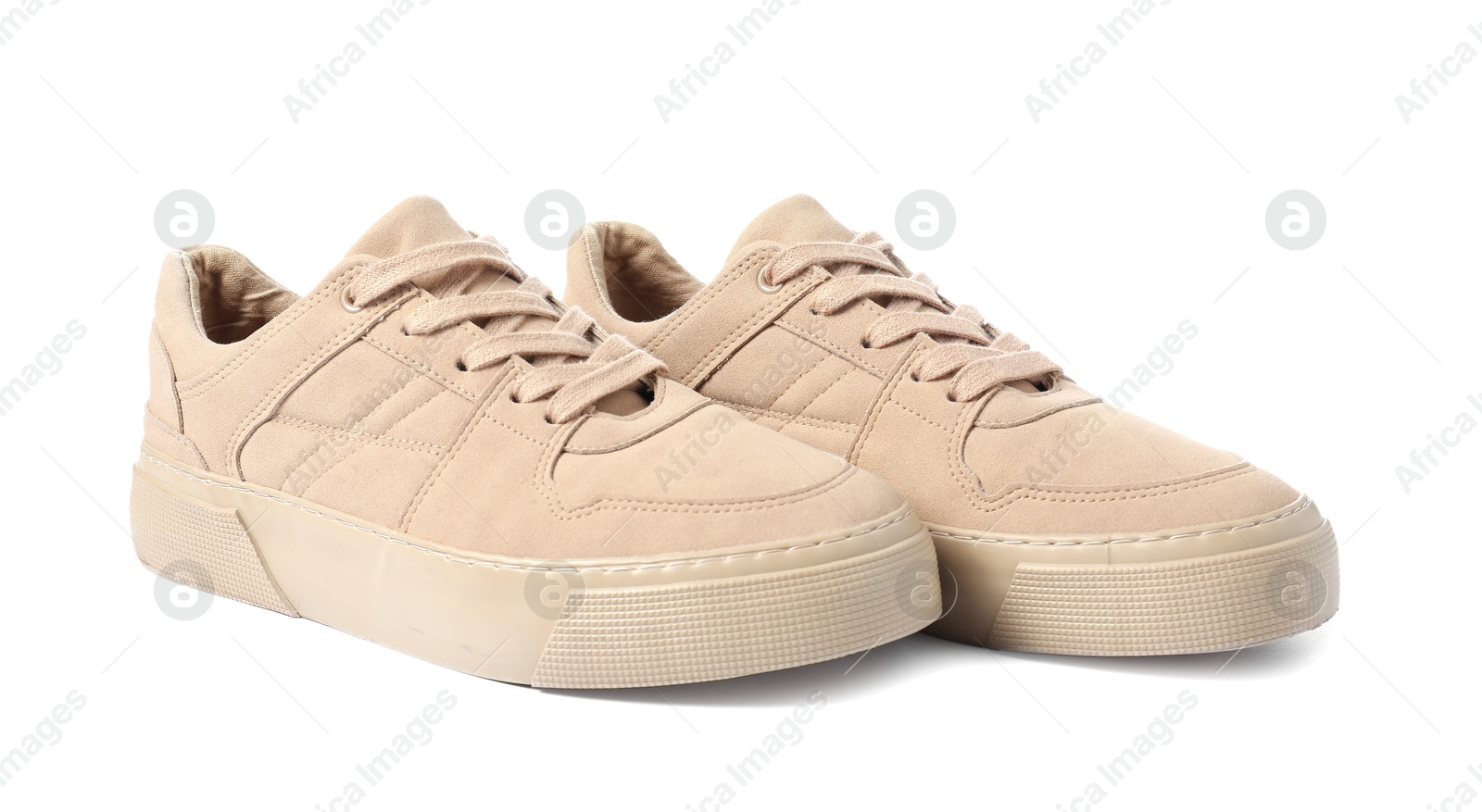 Photo of Pair of beige sneakers isolated on white. Sportive shoes