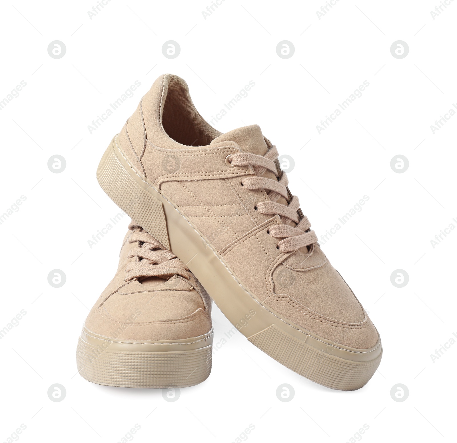 Photo of Pair of beige sneakers isolated on white. Sportive shoes