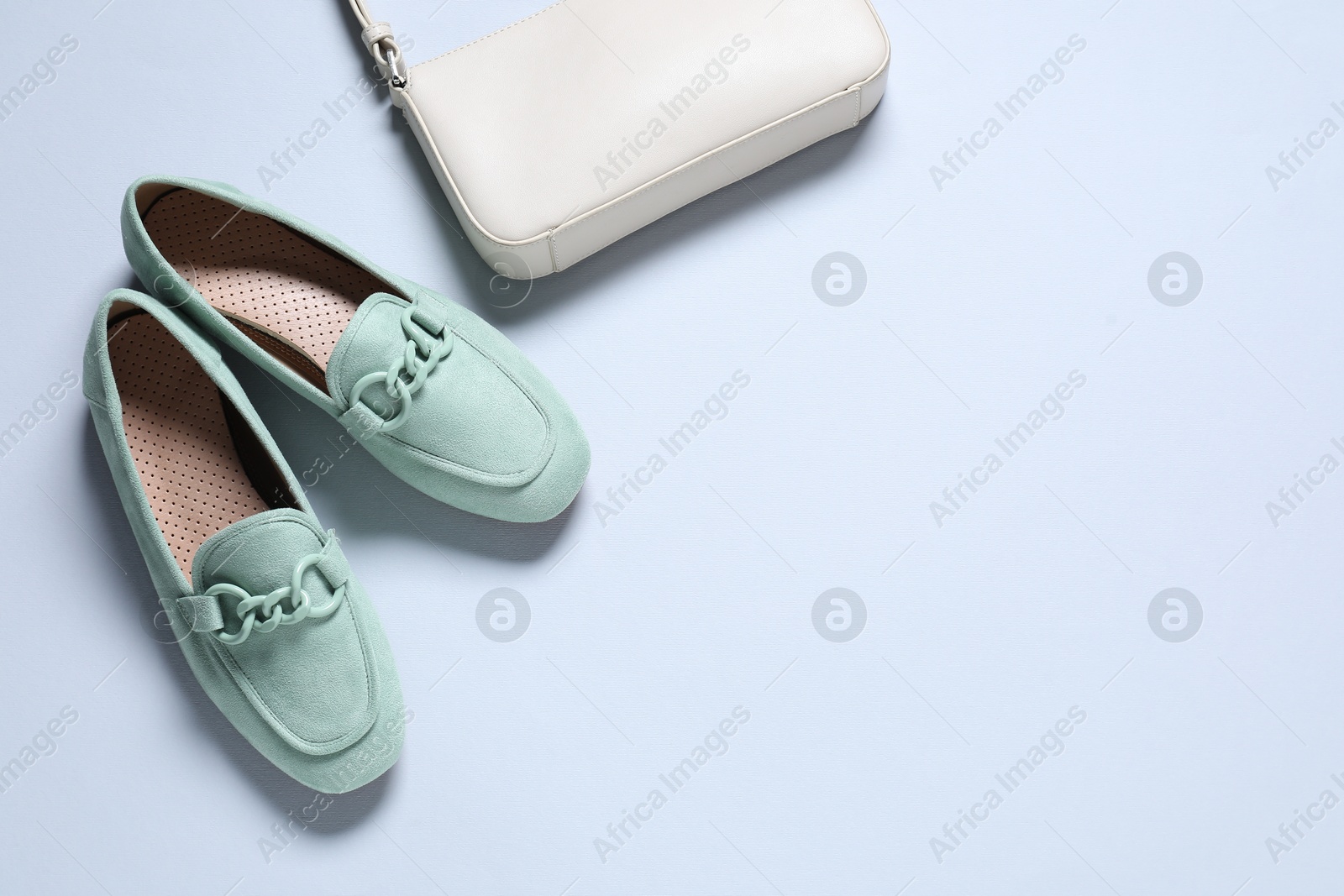 Photo of Pair of stylish shoes and bag on white background, flat lay. Space for text