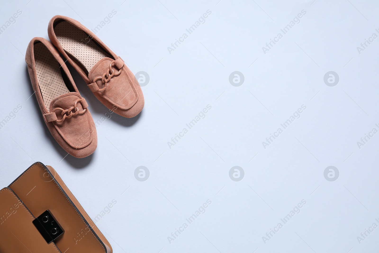 Photo of Stylish shoes and bag on white background, flat lay. Space for text