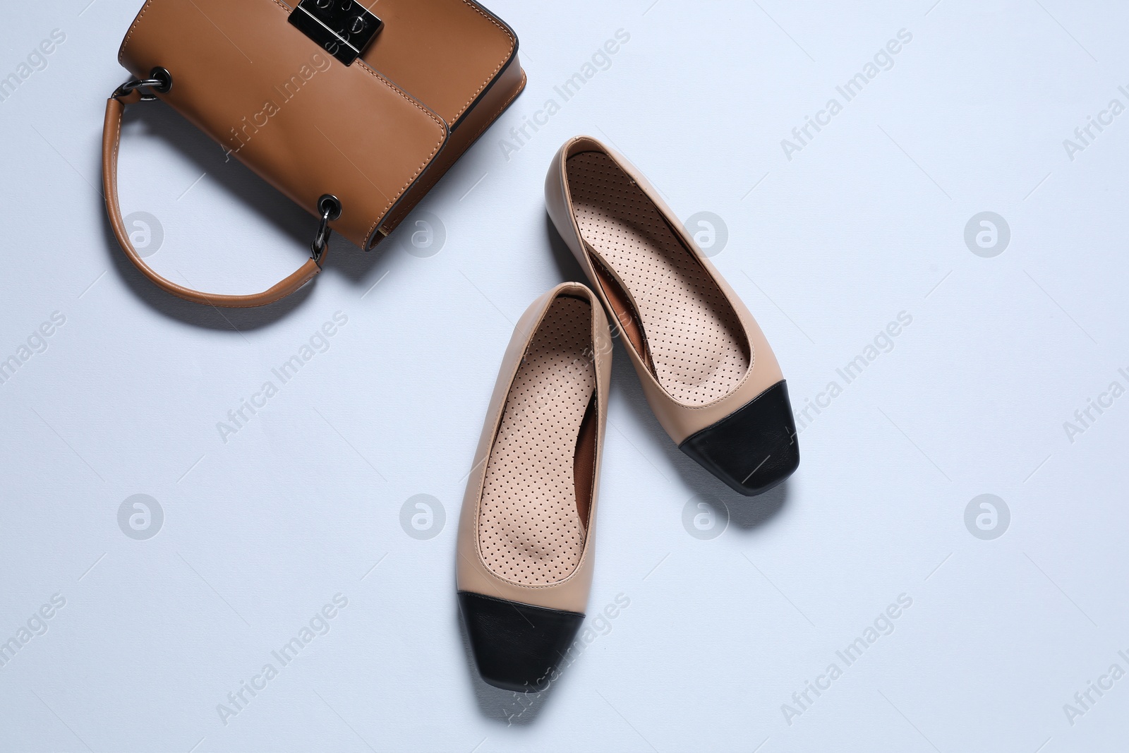 Photo of Stylish shoes and bag on white background, flat lay