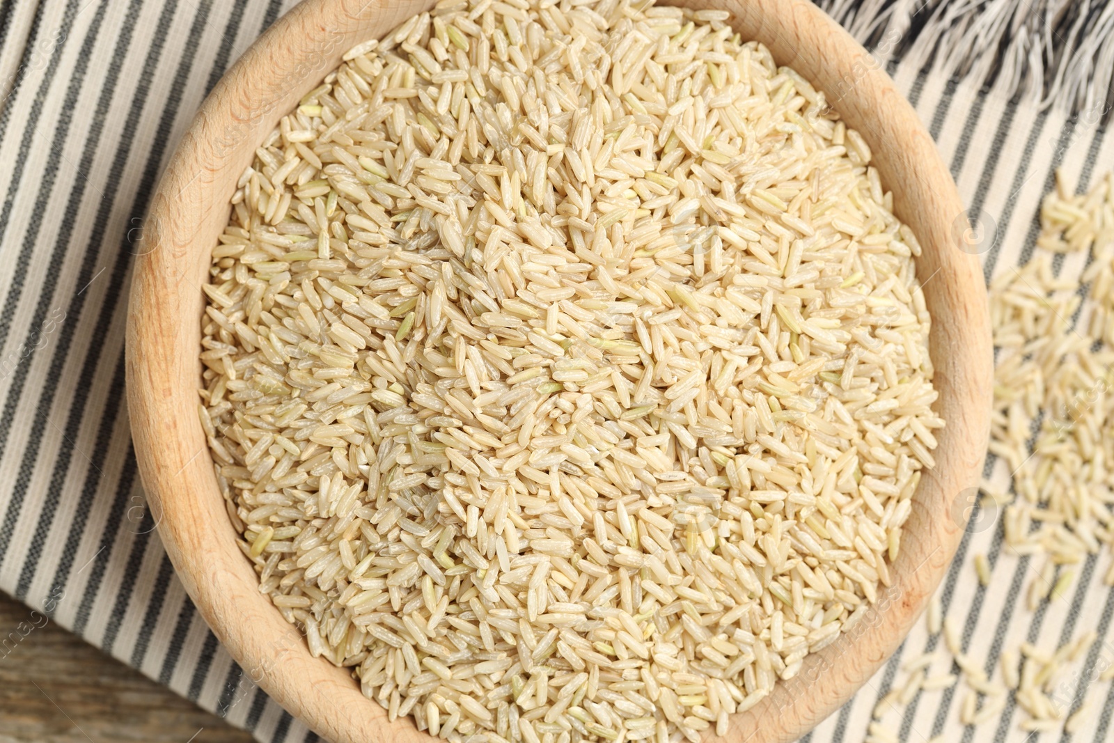 Photo of Brown rice in bowl on table, top view