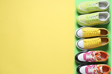 Photo of Sportive shoes. Different sneakers on color background, flat lay. Space for text