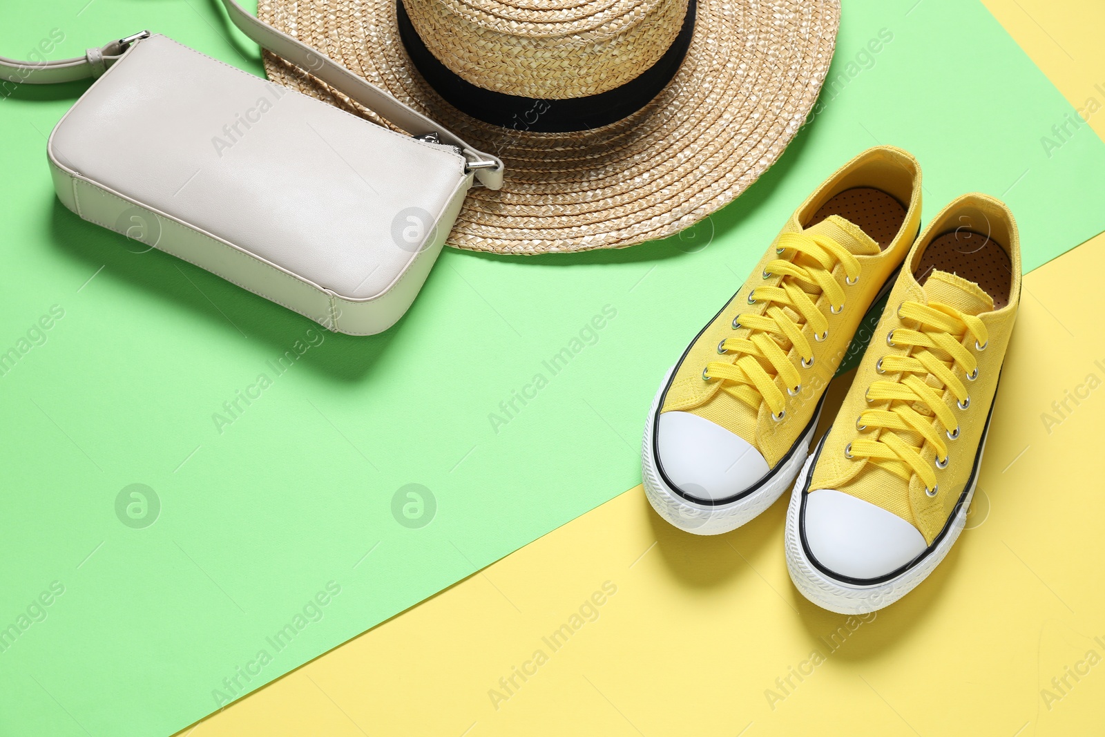 Photo of Stylish shoes, bag and hat on color background, above view. Space for text