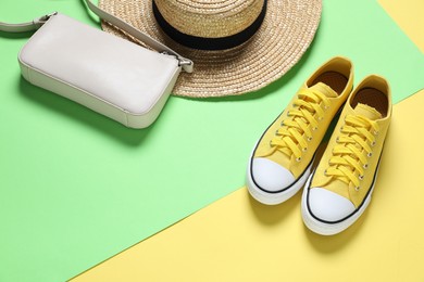 Photo of Stylish shoes, bag and hat on color background, above view. Space for text