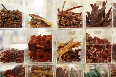 Photo of Display with different treats in pet shop, closeup