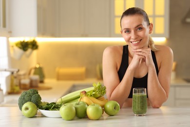 Photo of Weight loss. Happy woman with healthy shake at white marble table in kitchen