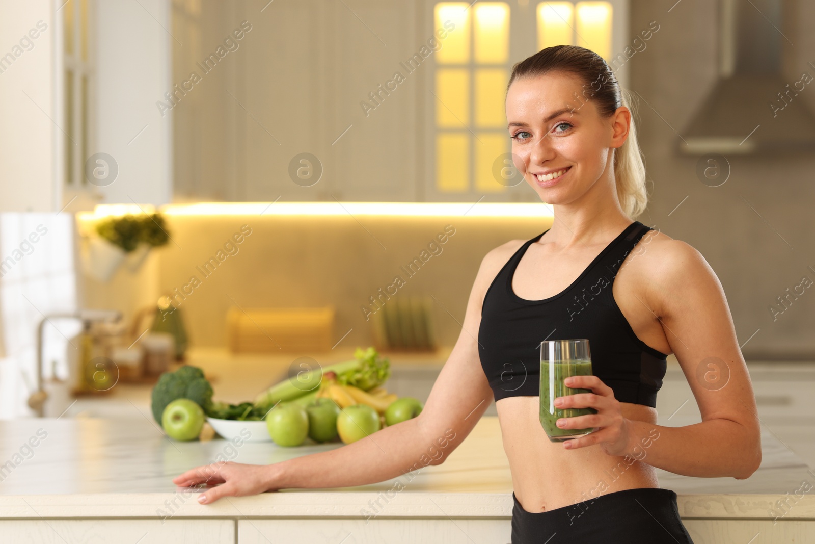 Photo of Weight loss. Happy woman with healthy shake in kitchen