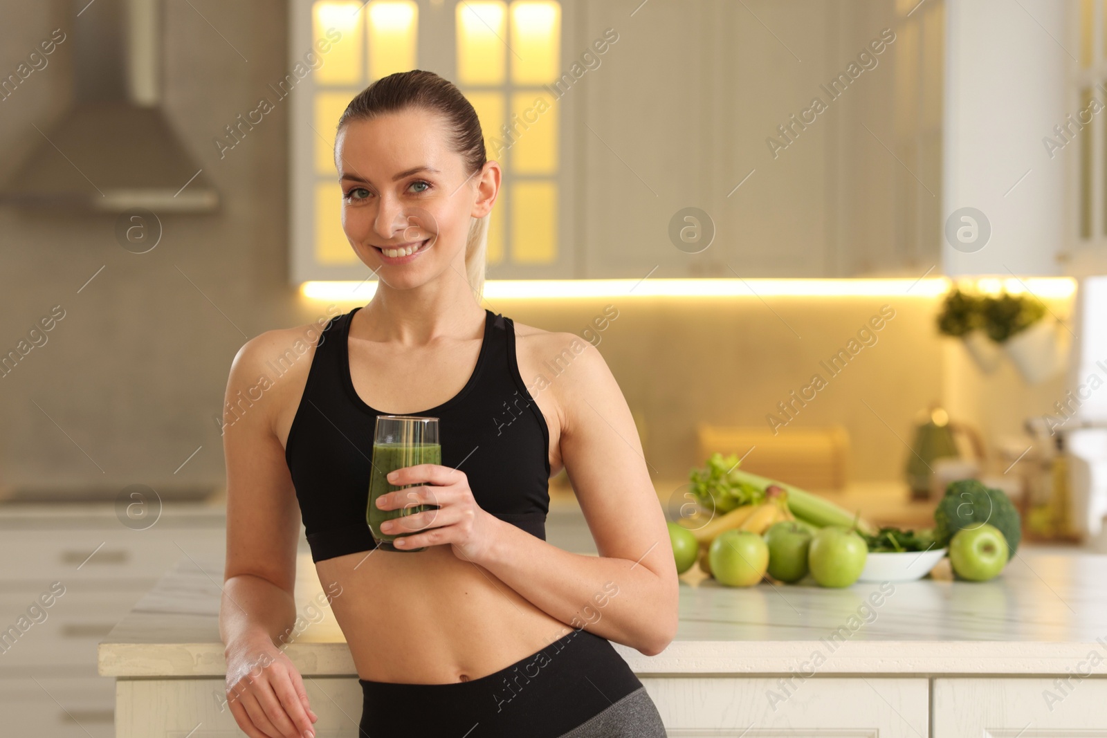 Photo of Weight loss. Happy woman with healthy shake in kitchen