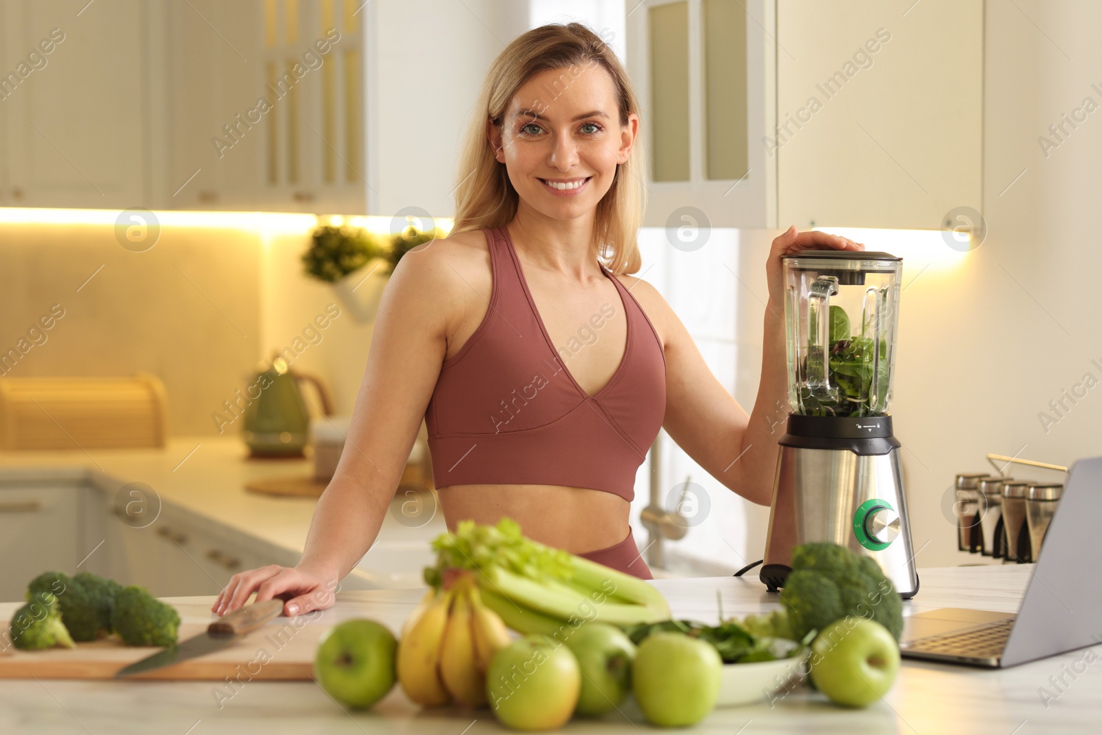 Photo of Weight loss. Woman making protein shake at table in kitchen