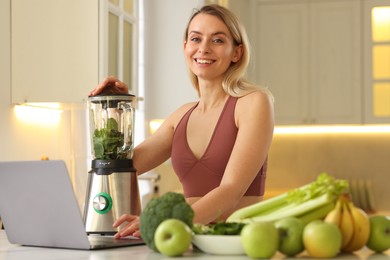 Photo of Weight loss. Woman making protein shake at table in kitchen