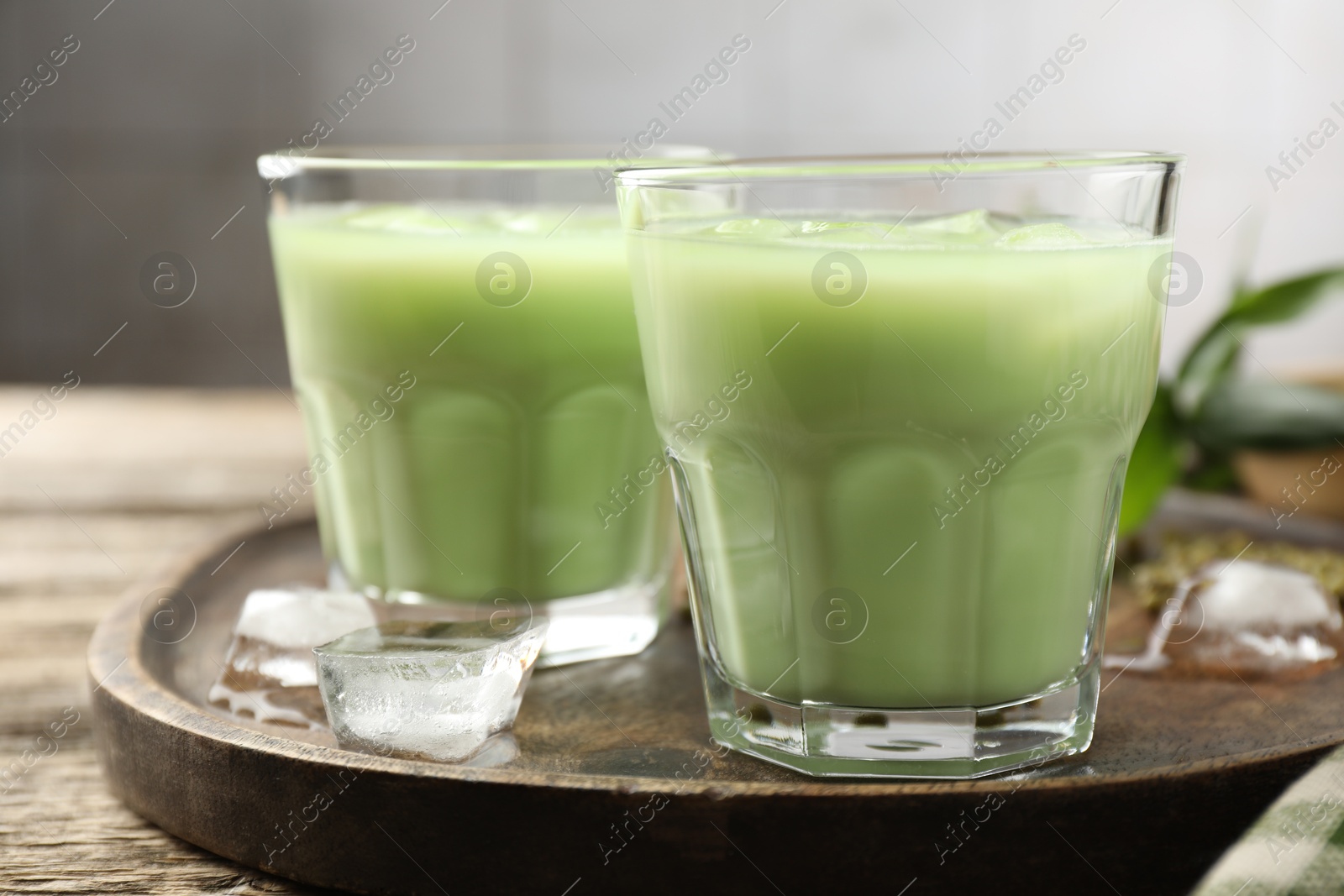 Fresh mung bean juice with ice in glasses on wooden table, closeup Photo of Fresh mung bean juice with ice in glasses on wooden table, closeup