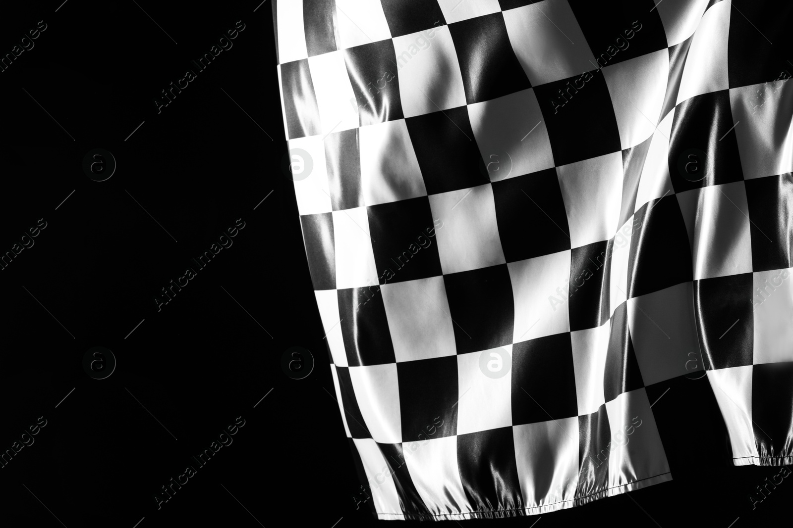 Photo of One racing checkered flag on black background, space for text