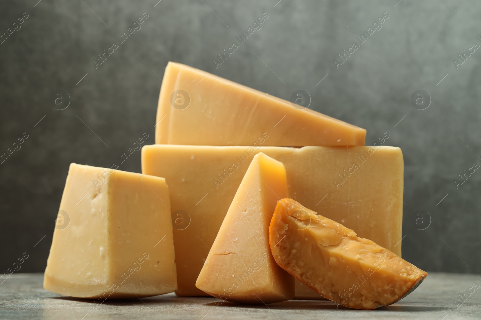 Photo of Different types of cheese on grey table