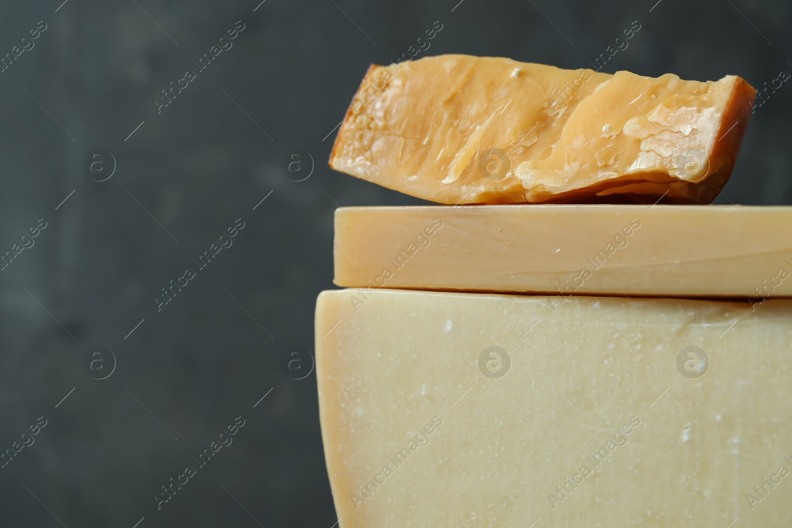 Photo of Different types of cheese on blurred background, closeup. Space for text