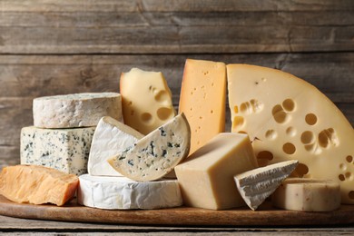 Photo of Different types of cheese on wooden table