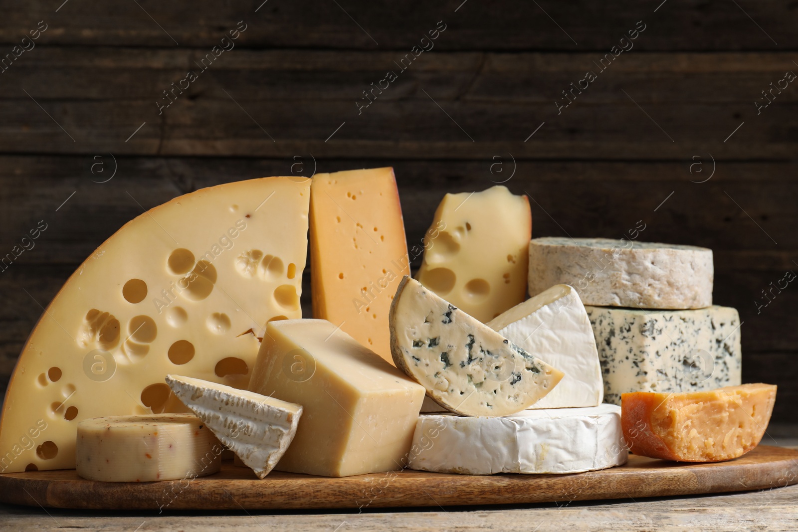 Photo of Different types of cheese on wooden table