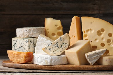 Photo of Different types of cheese on wooden table