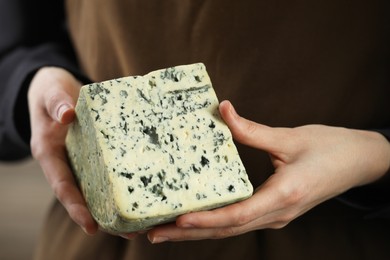 Photo of Woman with piece of delicious cheese, closeup