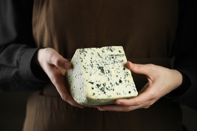 Photo of Woman with piece of delicious cheese, closeup