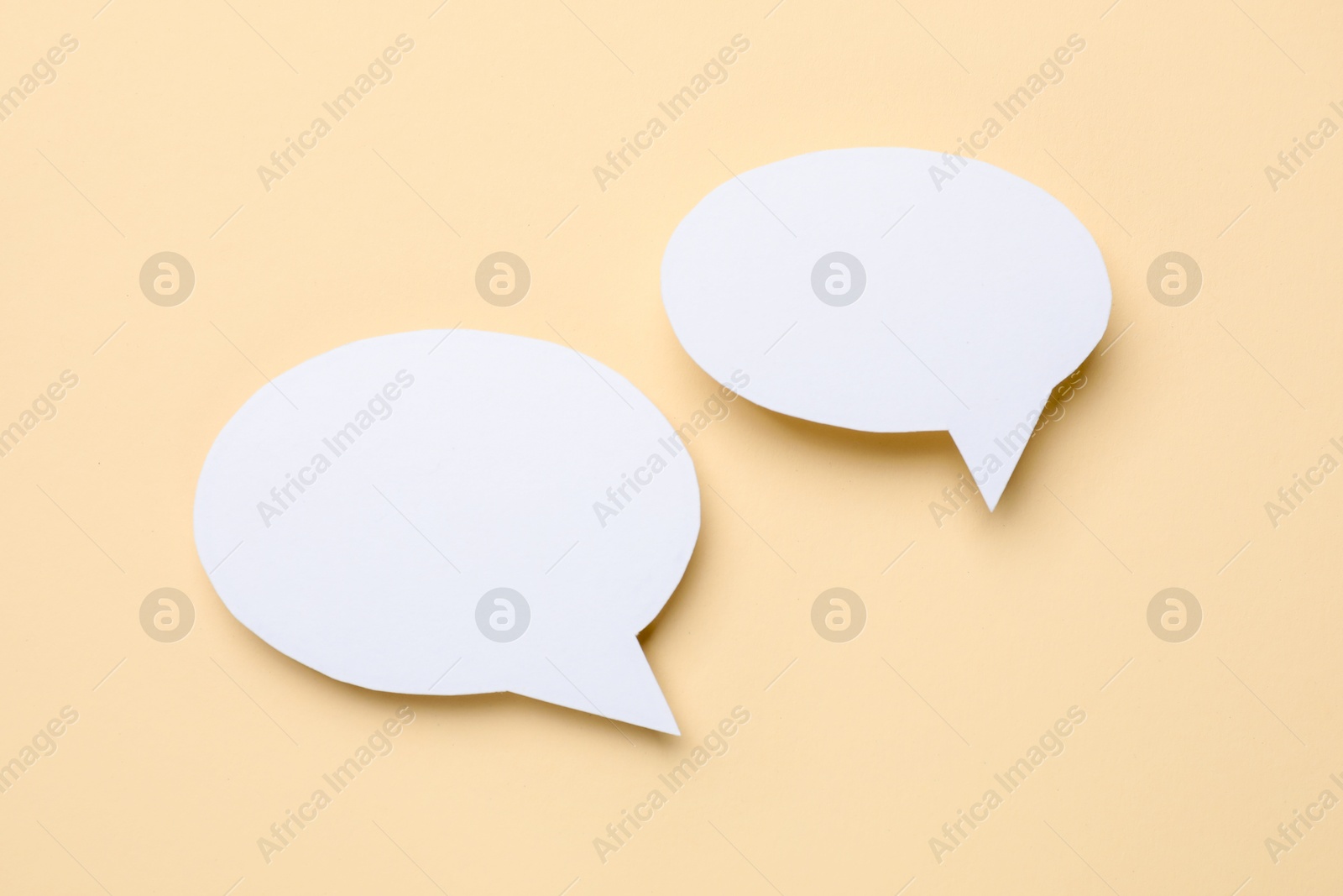 Photo of Blank speech bubbles on beige background. Space for text