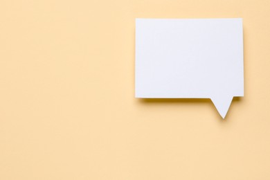 Photo of Blank speech bubble on beige background, top view. Space for text