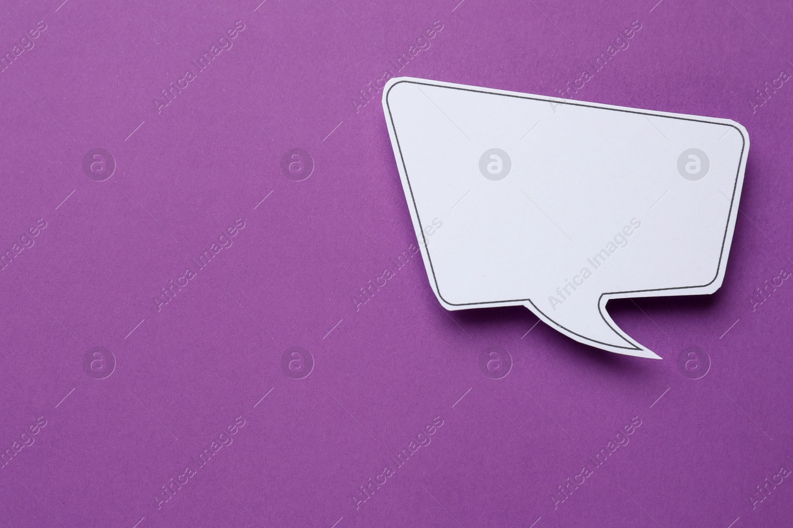 Photo of Blank speech bubble on purple background, top view. Space for text