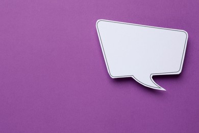 Photo of Blank speech bubble on purple background, top view. Space for text