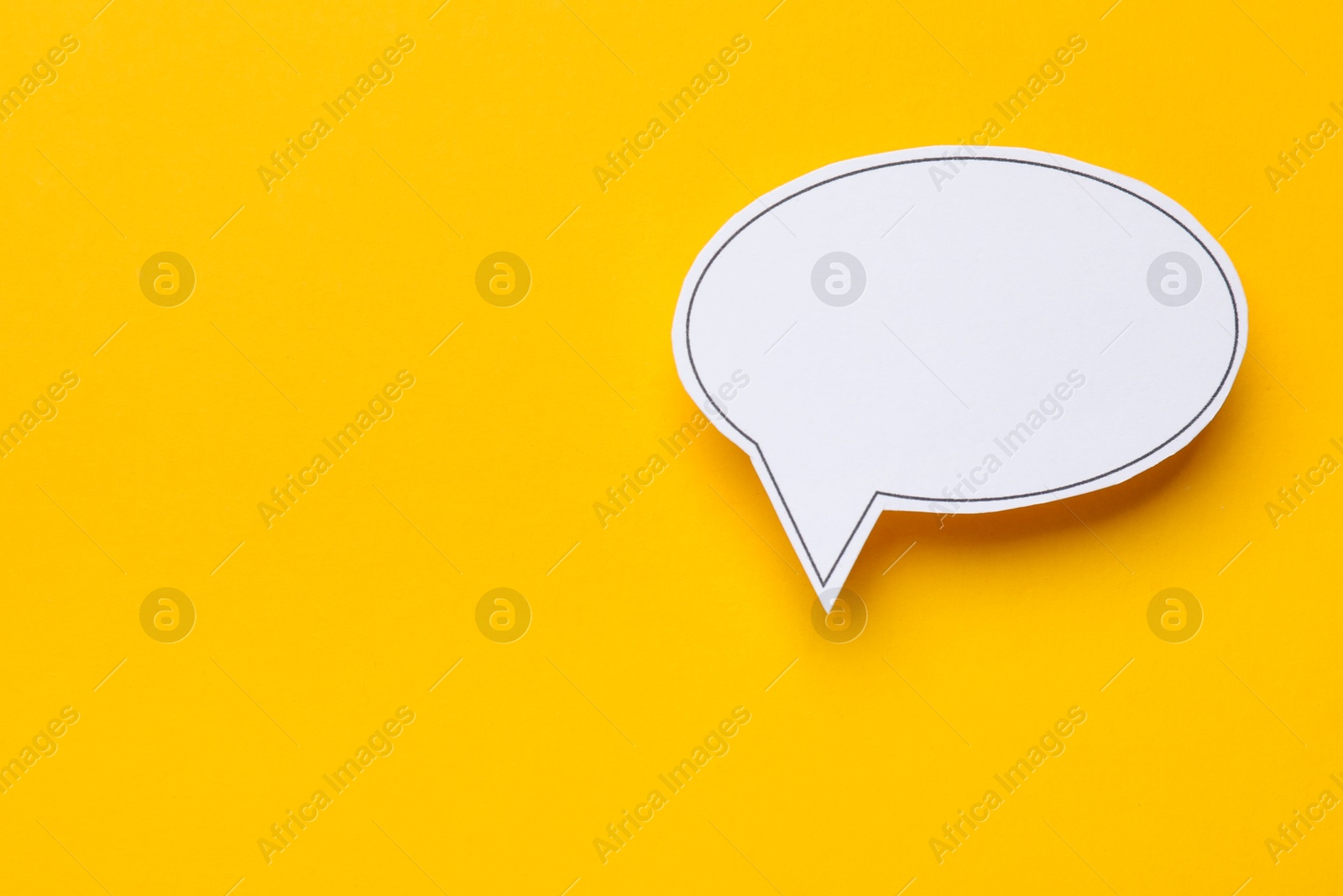 Photo of Blank speech bubble on yellow background, top view. Space for text