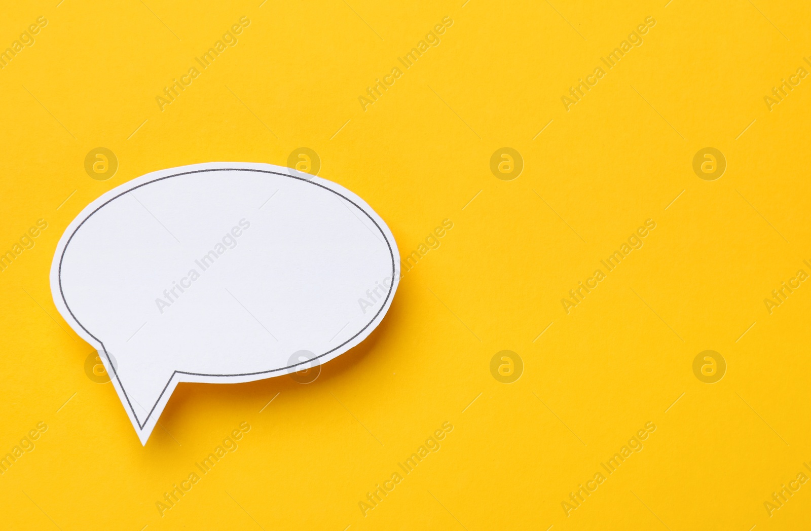 Photo of Blank speech bubble on yellow background, top view. Space for text