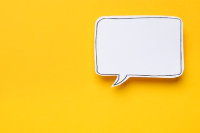 Photo of Blank speech bubble on yellow background, top view. Space for text