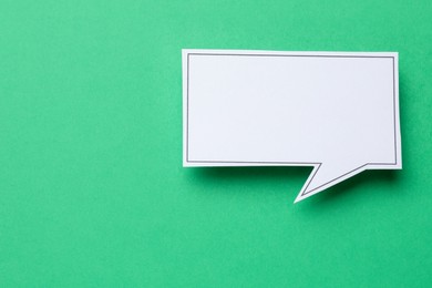 Photo of Blank speech bubble on green background, top view. Space for text