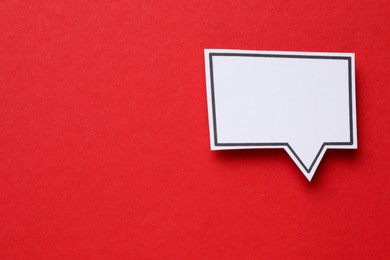 Photo of Blank speech bubble on red background, top view. Space for text