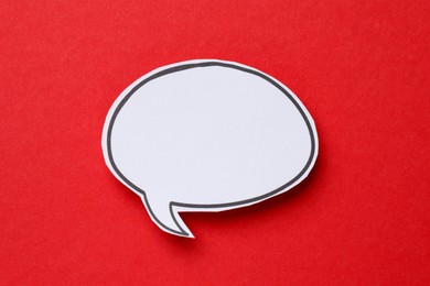 Photo of Blank speech bubble on red background, top view. Space for text