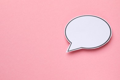 Photo of Blank speech bubble on light pink background, top view. Space for text