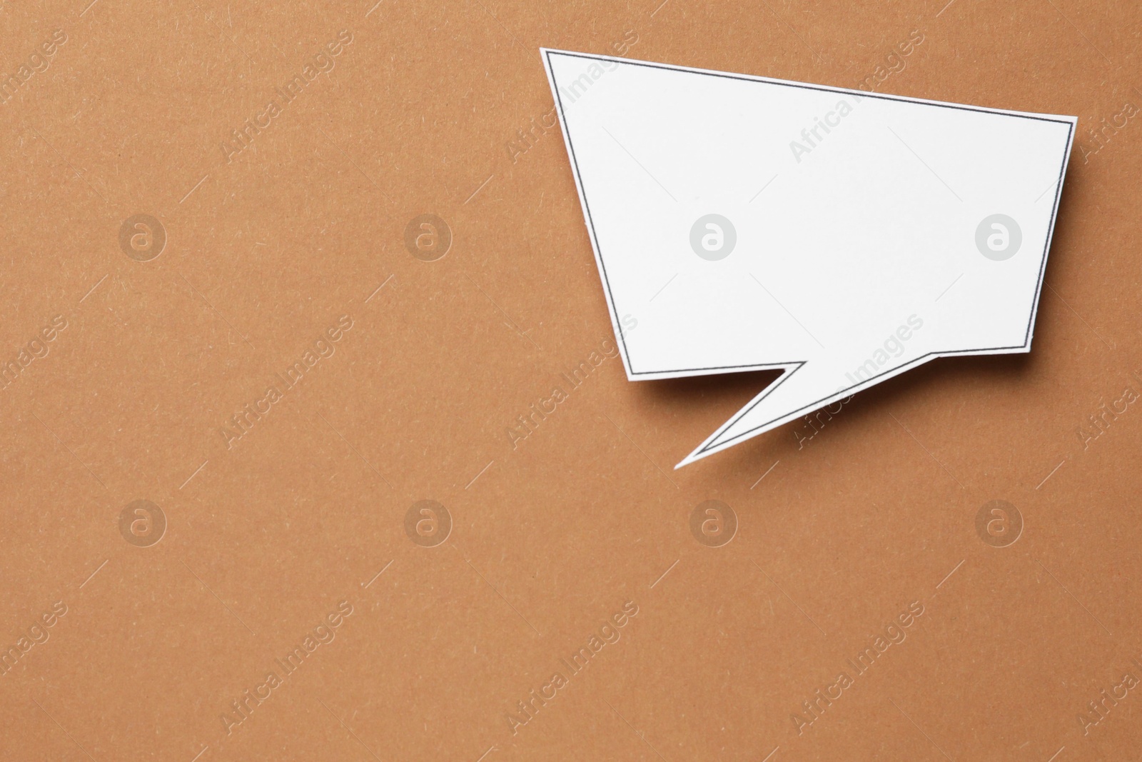 Photo of Blank speech bubble on brown background, top view. Space for text