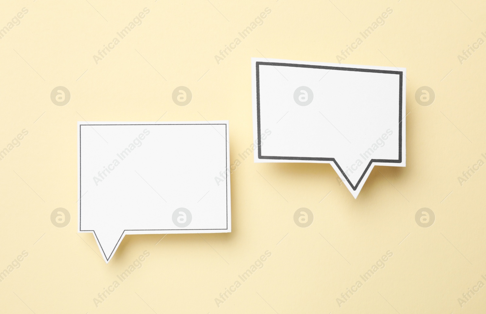 Photo of Blank speech bubbles on beige background, top view. Space for text